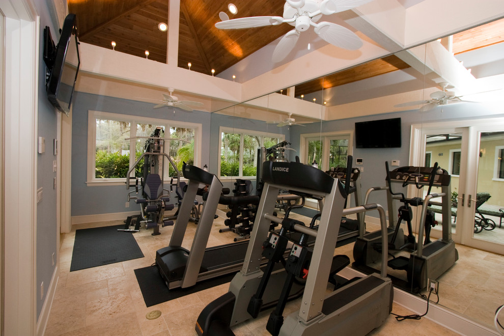Mid-sized traditional home weight room in Tampa with blue walls, limestone floors and beige floor.