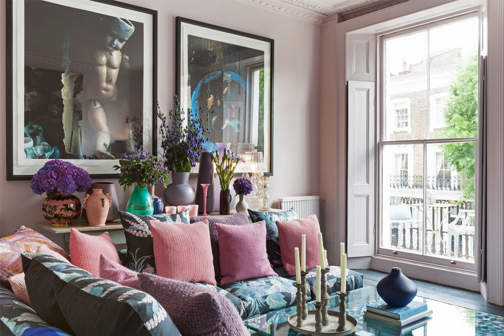 Design ideas for an eclectic living room in London with pink walls.