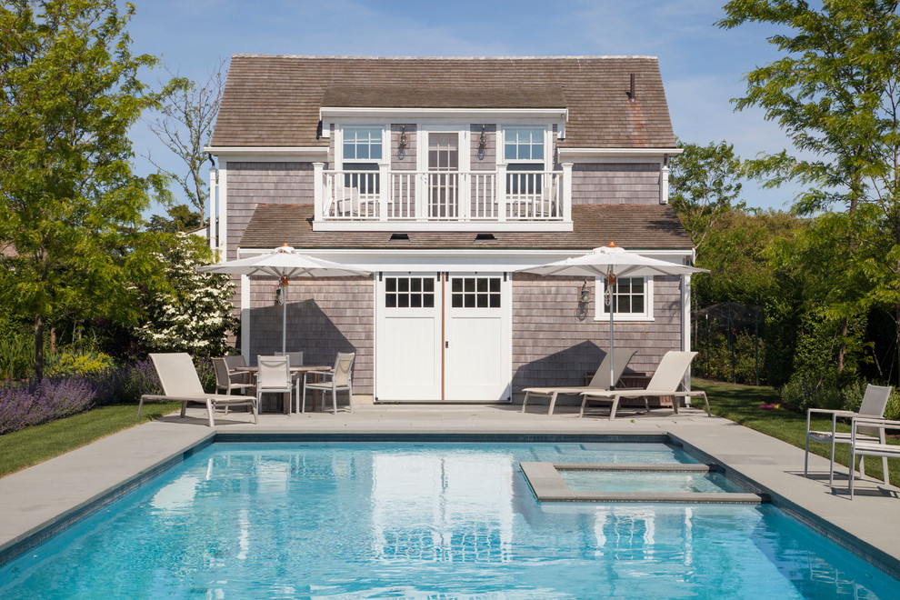 Inspiration for a large beach style rectangular pool in Boston with a pool house.