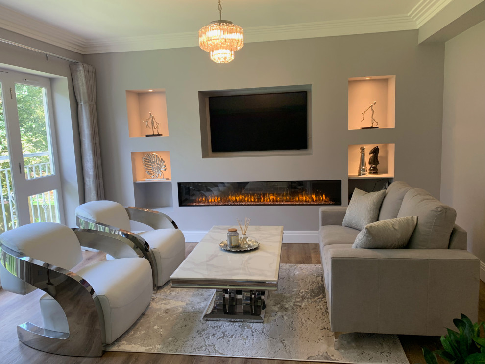 Example of a mid-sized trendy formal and open concept vinyl floor, brown floor, coffered ceiling and wall paneling living room design in Buckinghamshire with white walls, a ribbon fireplace, a plaster fireplace and a media wall