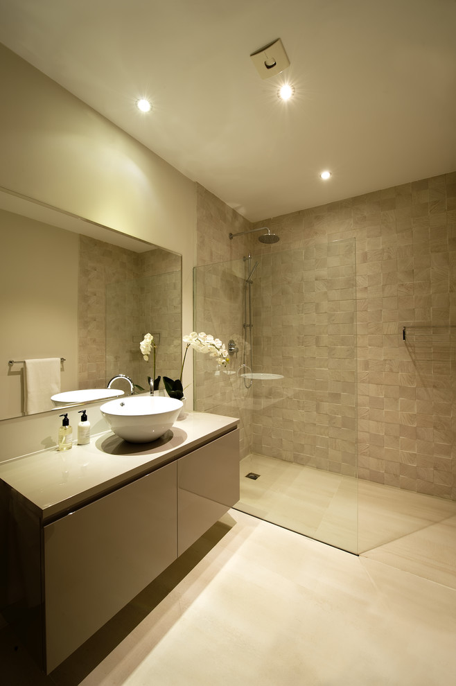 This is an example of a mid-sized contemporary 3/4 bathroom in Other with flat-panel cabinets, grey cabinets, a curbless shower, beige walls and a vessel sink.