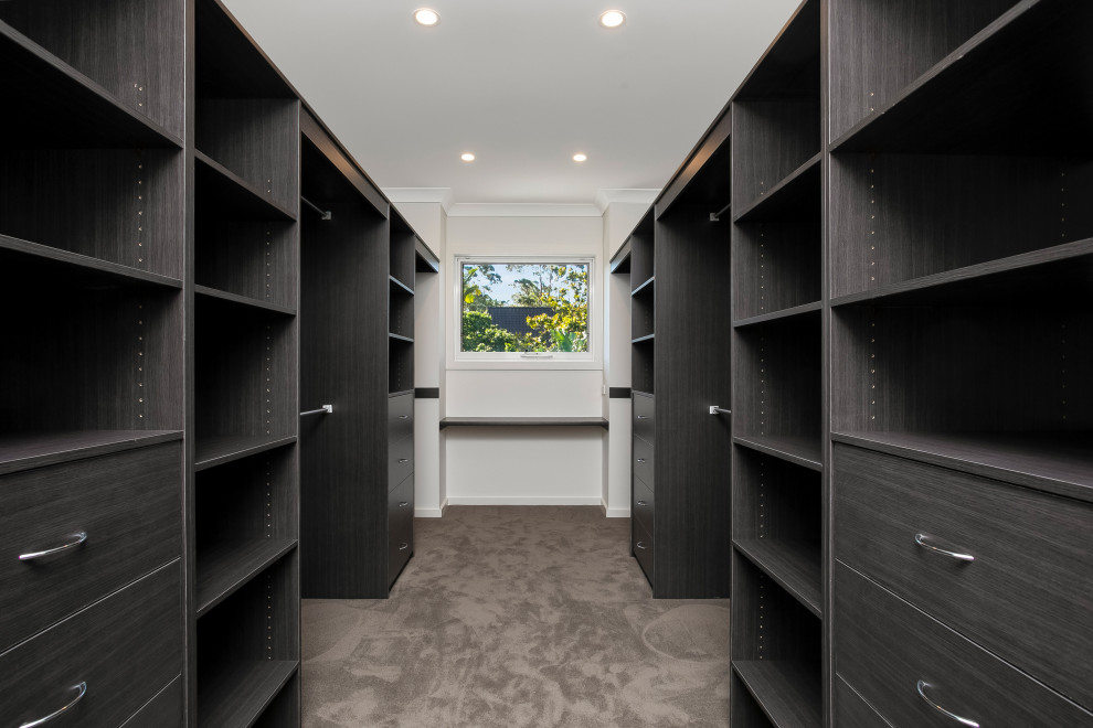 This is an example of a mid-sized contemporary walk-in wardrobe in Sydney.