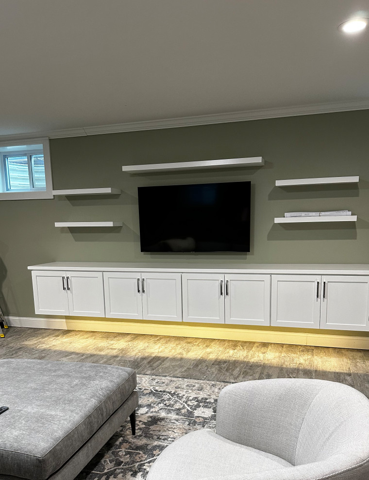 This is an example of a mid-sized transitional open concept family room in DC Metro with green walls, ceramic floors, no fireplace, a wall-mounted tv and grey floor.