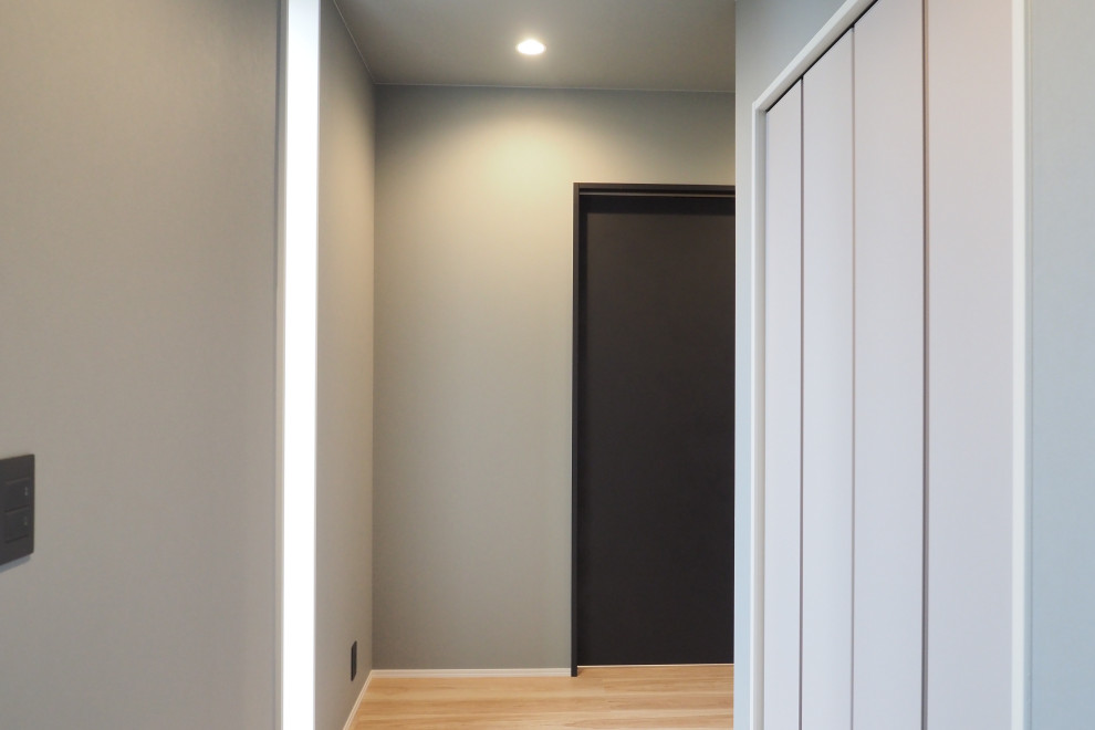 На фото: коридор в стиле модернизм с серыми стенами, полом из фанеры, бежевым полом, потолком с обоями и обоями на стенах с
