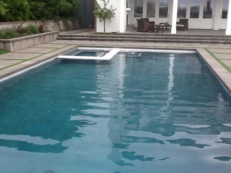 Mid-sized traditional backyard rectangular lap pool in Los Angeles with tile.