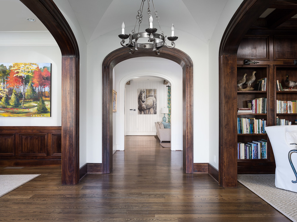 Traditional foyer in Atlanta with white walls and dark hardwood floors.