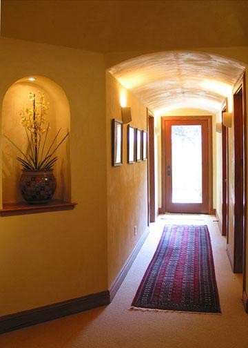 Photo of a large mediterranean hallway in San Francisco with yellow walls, carpet and beige floor.