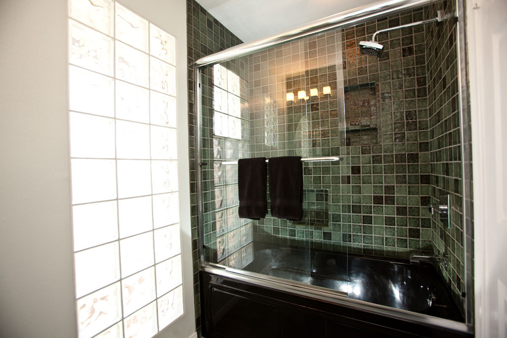 This is an example of an eclectic bathroom in Los Angeles with a drop-in tub, a shower/bathtub combo, green tile, mosaic tile and white walls.
