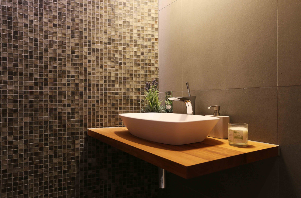 Inspiration for a contemporary bathroom in London with a walk-in shower, grey tiles, glass tiles, ceramic flooring, a console sink, wooden worktops, grey floors, an open shower, brown worktops, a single sink and a floating vanity unit.