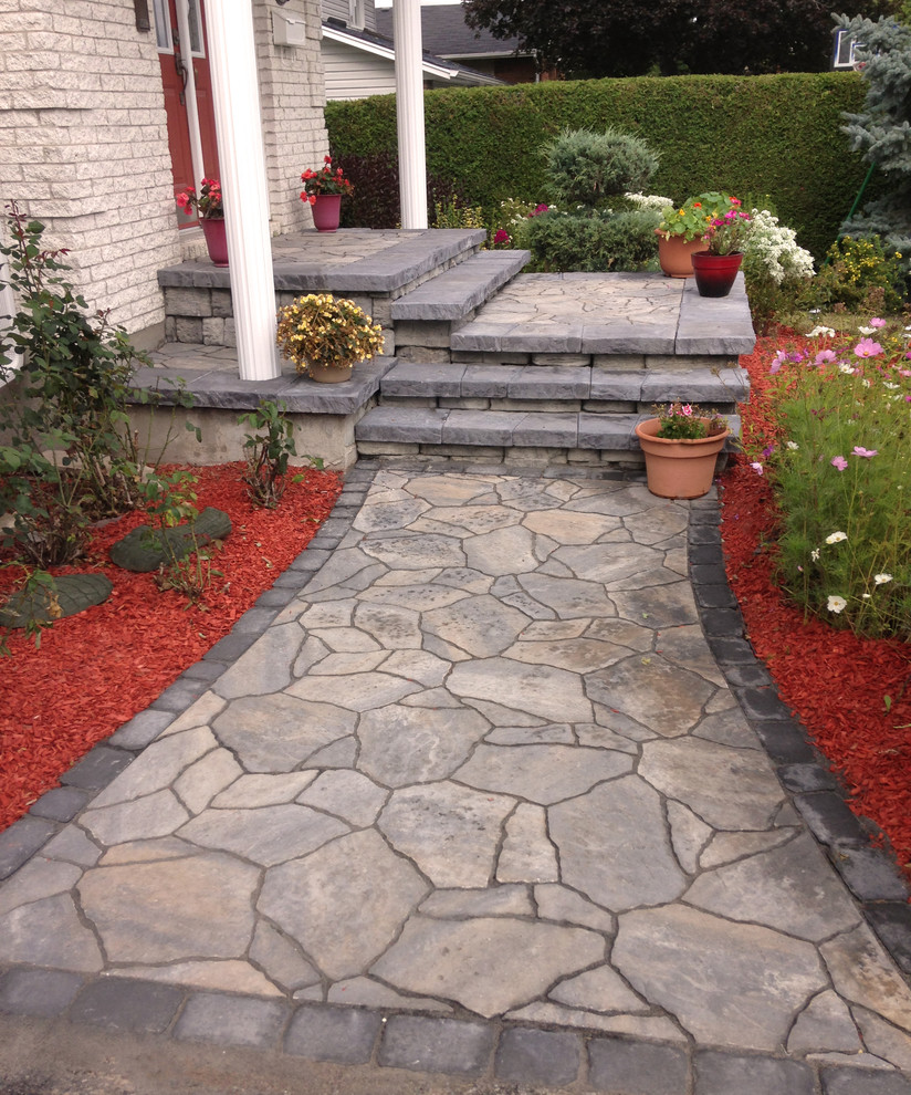 Mid-sized mountain style stone front porch idea in Ottawa with a roof extension