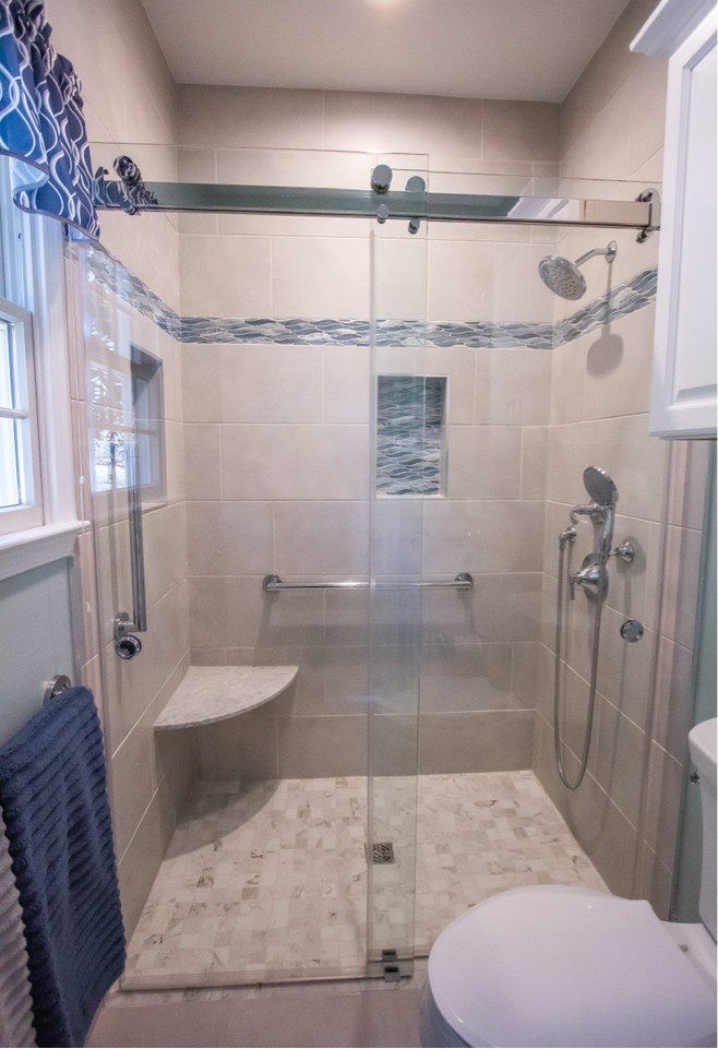 Photo of a small transitional master bathroom in Baltimore with white cabinets, a curbless shower, a two-piece toilet, beige tile, porcelain tile, blue walls, porcelain floors, an integrated sink, marble benchtops, beige floor, a sliding shower screen, white benchtops, a single vanity and a built-in vanity.