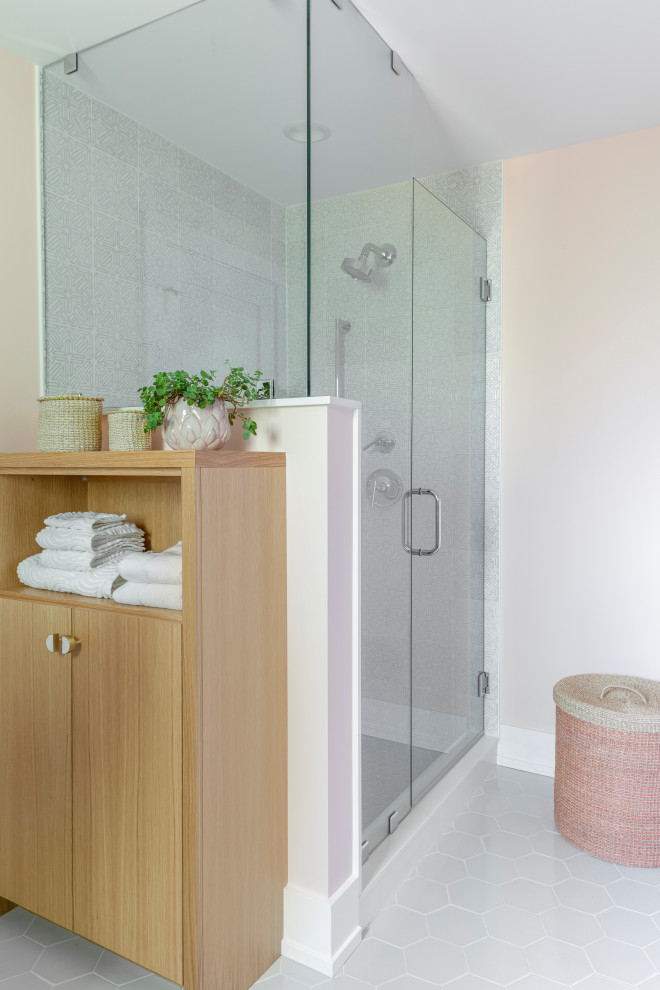 This is an example of a mid-sized transitional kids bathroom in Chicago with flat-panel cabinets, light wood cabinets, a corner shower, a two-piece toilet, white tile, mosaic tile, pink walls, an undermount sink, engineered quartz benchtops, grey floor, a hinged shower door and white benchtops.