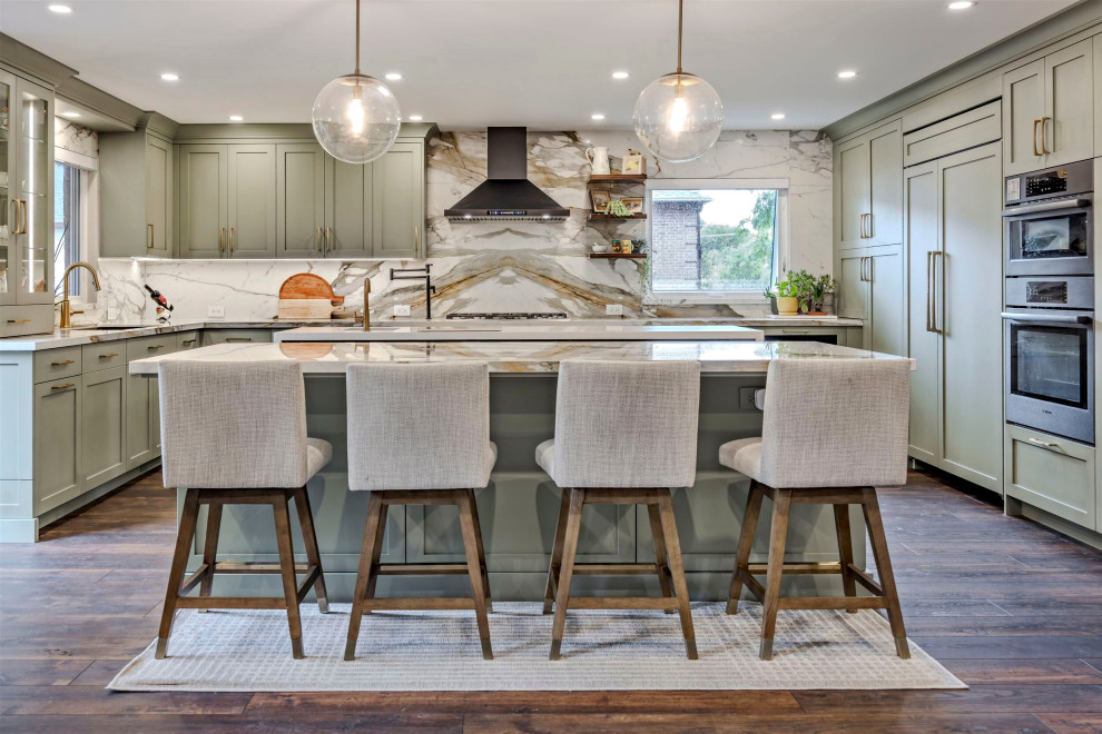 Eat-in kitchen - huge transitional u-shaped vinyl floor and brown floor eat-in kitchen idea in Toronto with an undermount sink, shaker cabinets, green cabinets, quartz countertops, white backsplash, quartz backsplash, stainless steel appliances, two islands and white countertops