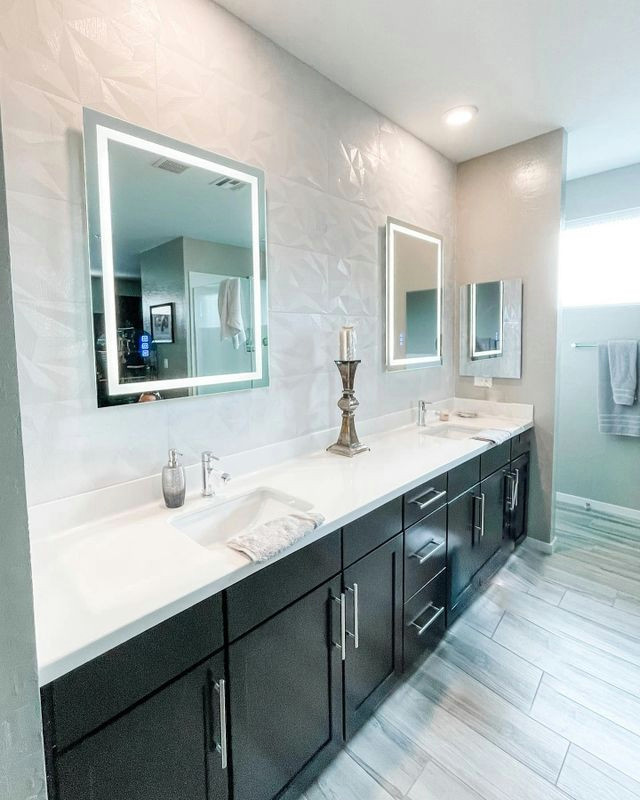 Large modern master wet room bathroom in Las Vegas with shaker cabinets, black cabinets, a freestanding tub, black tile, stone slab, white walls, ceramic floors, grey floor, a hinged shower door, a single vanity, a built-in vanity, an undermount sink and white benchtops.