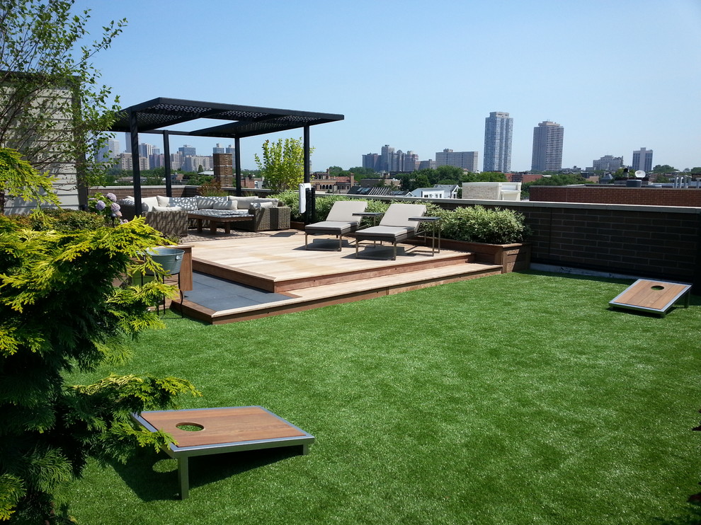 Photo of a large contemporary rooftop deck in Chicago with a pergola.
