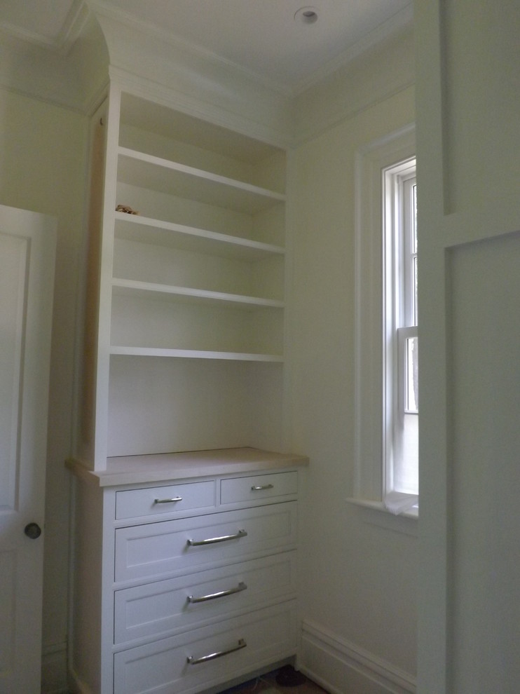 Photo of a large traditional gender-neutral walk-in wardrobe in Atlanta with recessed-panel cabinets, white cabinets and medium hardwood floors.