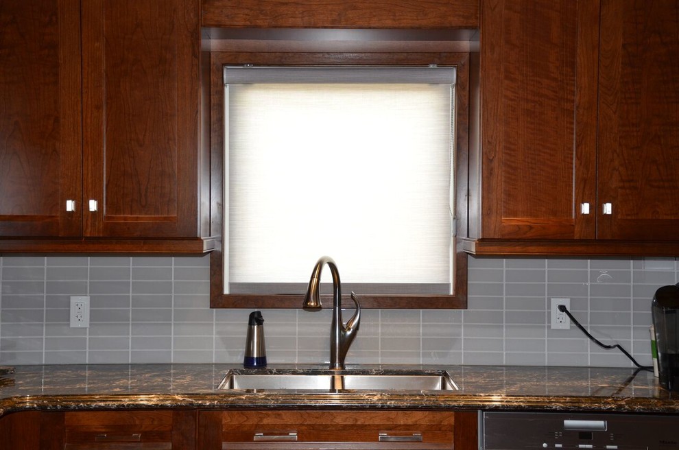Inspiration for a large transitional l-shaped medium tone wood floor open concept kitchen remodel in Toronto with an undermount sink, recessed-panel cabinets, dark wood cabinets, quartzite countertops, gray backsplash, glass tile backsplash, stainless steel appliances and an island