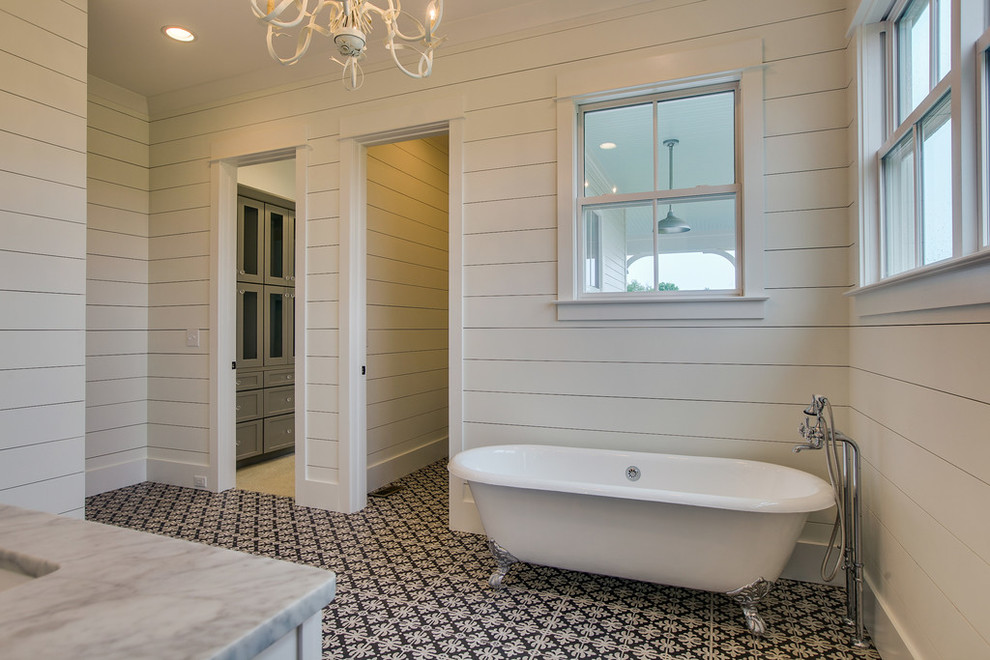 Design ideas for a large country 3/4 bathroom in Nashville with a two-piece toilet, ceramic tile, white walls, ceramic floors, solid surface benchtops, white cabinets, a claw-foot tub, black and white tile, an undermount sink, shaker cabinets and an alcove shower.