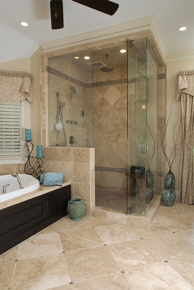 Photo of a large traditional master bathroom in Atlanta with an undermount sink, dark wood cabinets, marble benchtops, a corner shower, recessed-panel cabinets, a drop-in tub, mosaic tile, beige walls and travertine floors.