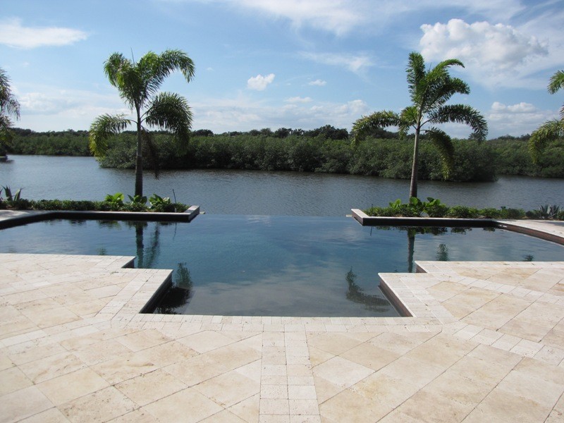 Pool - mid-sized modern backyard stone and rectangular natural pool idea in Miami