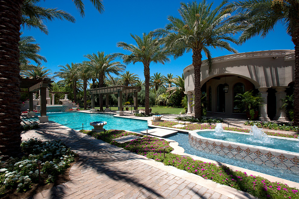 Inspiration for a huge transitional backyard brick and rectangular pool fountain remodel in Phoenix