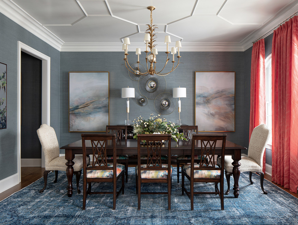 Example of a large classic medium tone wood floor, brown floor and wallpaper enclosed dining room design in Richmond with blue walls