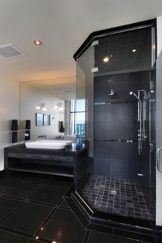 Photo of a contemporary bathroom with a vessel sink and black tile.