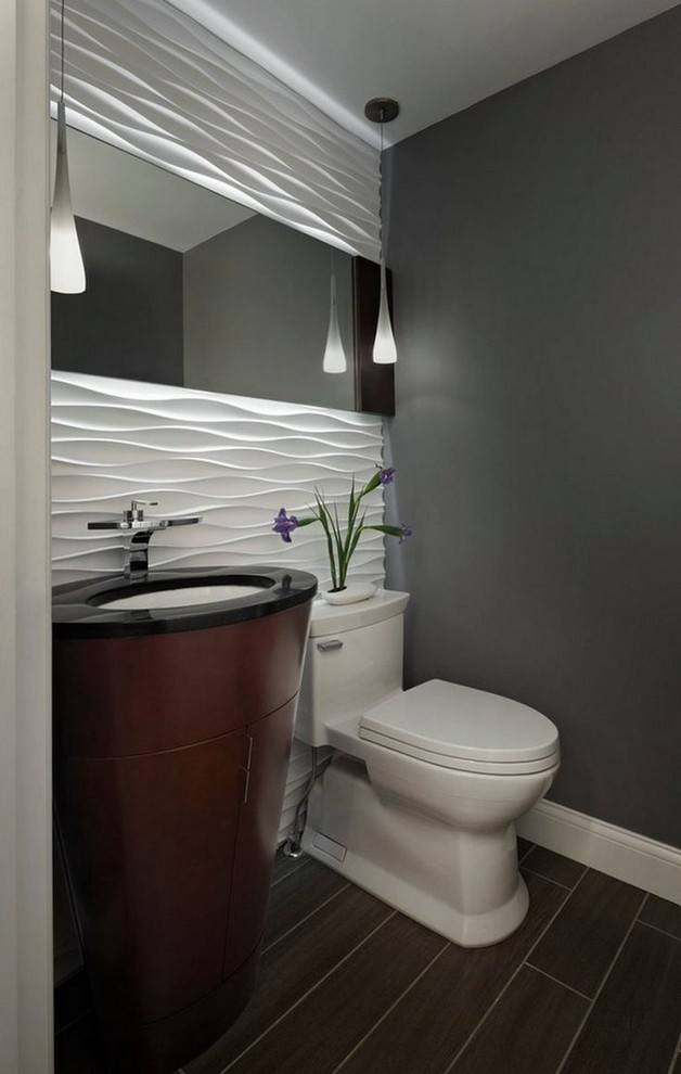 This is an example of a small contemporary powder room in San Francisco with grey walls, a one-piece toilet, dark wood cabinets, white tile, ceramic tile, porcelain floors, an undermount sink, granite benchtops, grey floor and black benchtops.