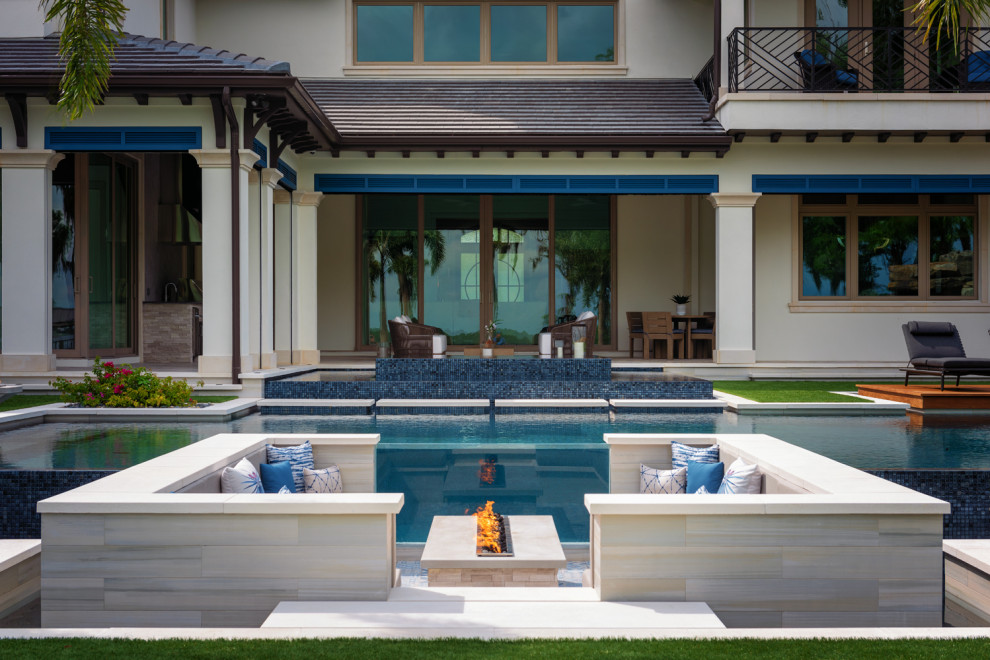 Стильный дизайн: большой бассейн произвольной формы на заднем дворе в современном стиле с покрытием из плитки - последний тренд