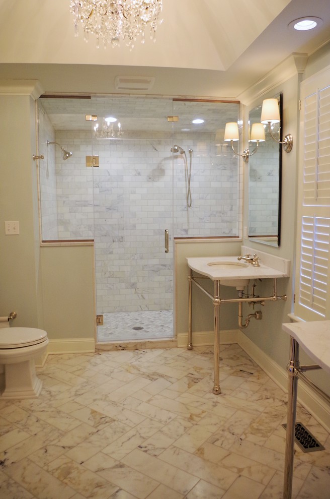 This is an example of a mid-sized traditional master bathroom in St Louis with raised-panel cabinets, medium wood cabinets, a corner shower, grey walls, porcelain floors, an integrated sink, onyx benchtops, multi-coloured floor and a hinged shower door.