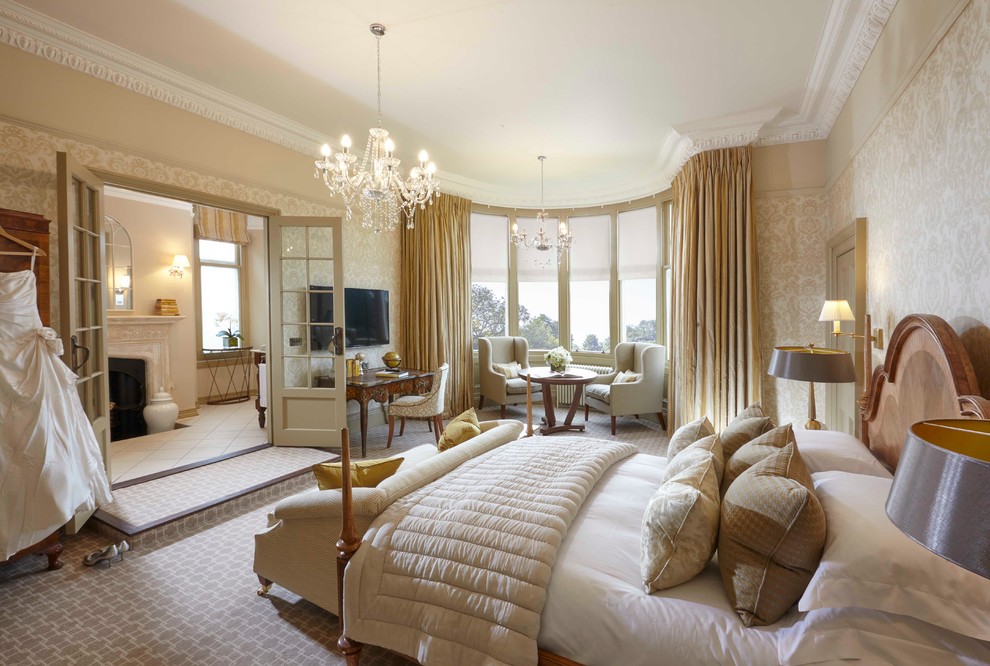 Inspiration for a large traditional master bedroom in Other with beige walls and carpet.