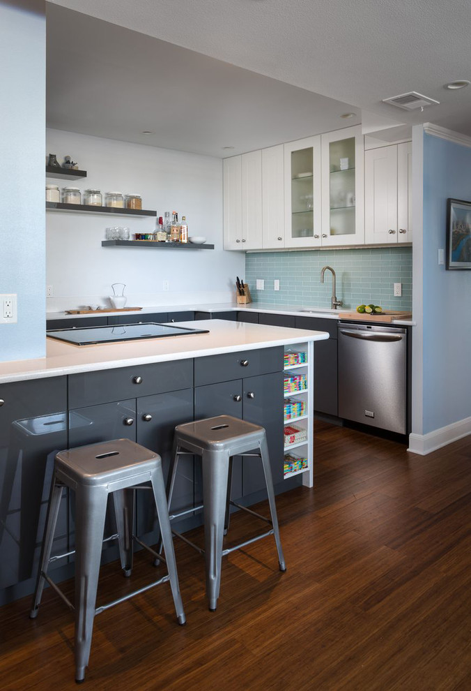 Inspiration for a contemporary kitchen in Austin with flat-panel cabinets, grey cabinets, quartz benchtops, blue splashback, subway tile splashback and stainless steel appliances.