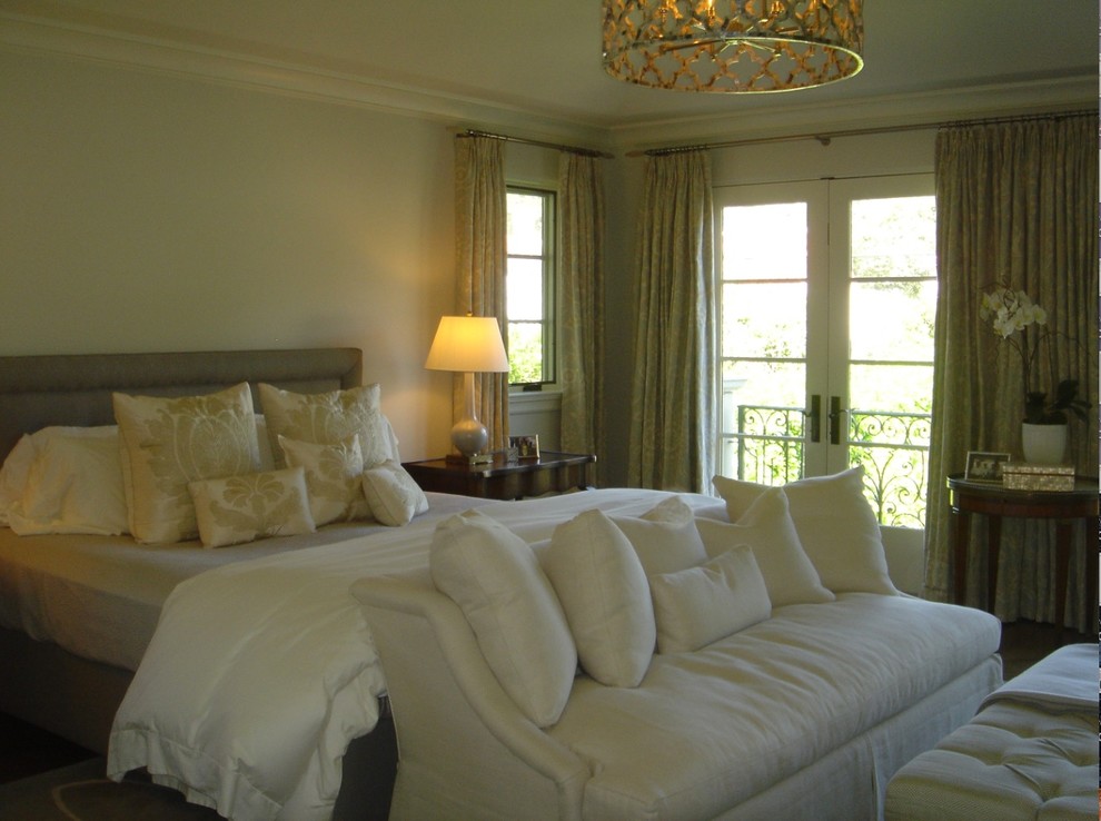 Large transitional master medium tone wood floor and brown floor bedroom photo with gray walls