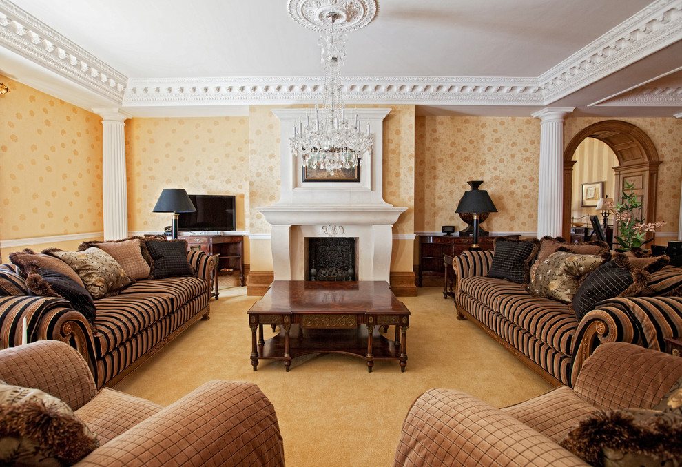 This is an example of a large traditional living room in Surrey with yellow walls, carpet, a standard fireplace, a stone fireplace surround and yellow floor.