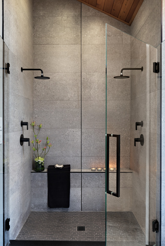Large trendy master gray tile and cement tile gray floor and concrete floor double shower photo in Other with medium tone wood cabinets, a one-piece toilet, gray walls, a vessel sink, a hinged shower door, black countertops and concrete countertops