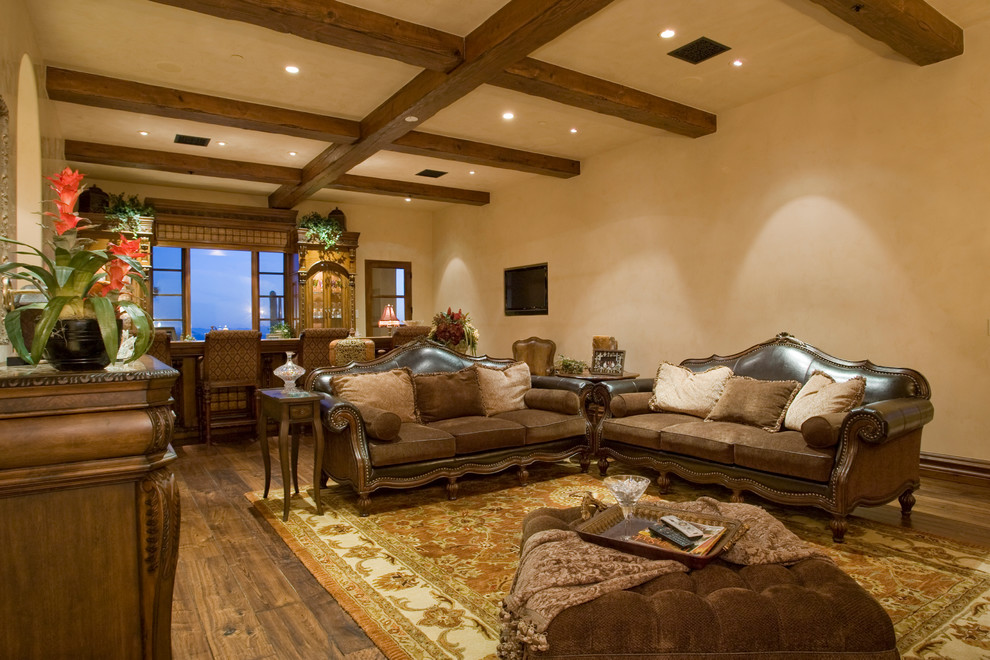 Expansive transitional open concept living room in Phoenix with a home bar, beige walls, medium hardwood floors, a standard fireplace and a freestanding tv.