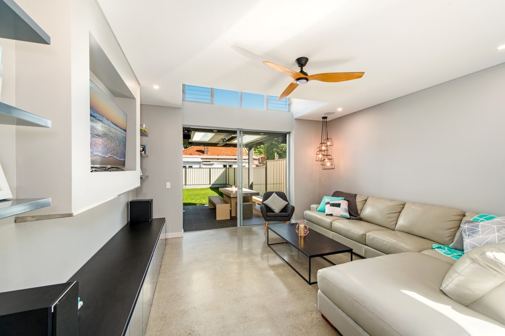 Mid-sized contemporary formal open concept living room in Sydney with grey walls, concrete floors and a built-in media wall.