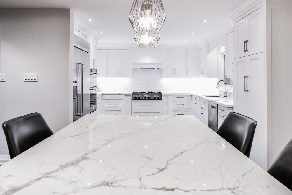 Trendy dark wood floor kitchen photo in Toronto with a drop-in sink, shaker cabinets, white cabinets, solid surface countertops, gray backsplash, ceramic backsplash, stainless steel appliances, an island and multicolored countertops