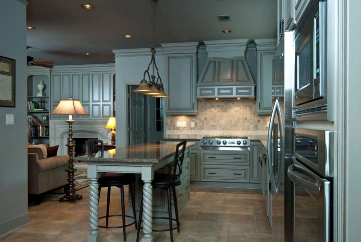 Example of a small l-shaped ceramic tile eat-in kitchen design with a single-bowl sink, flat-panel cabinets, gray cabinets, granite countertops and stainless steel appliances