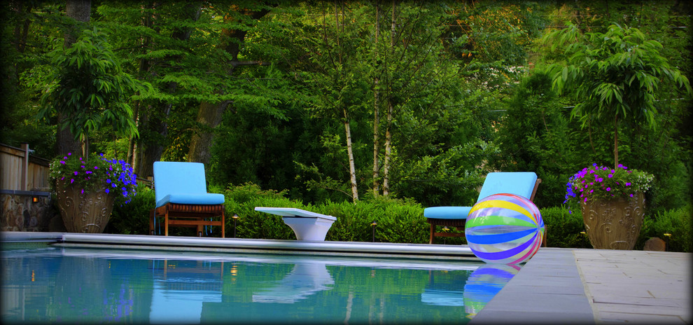 Huge transitional backyard concrete paver and rectangular lap pool fountain photo in DC Metro