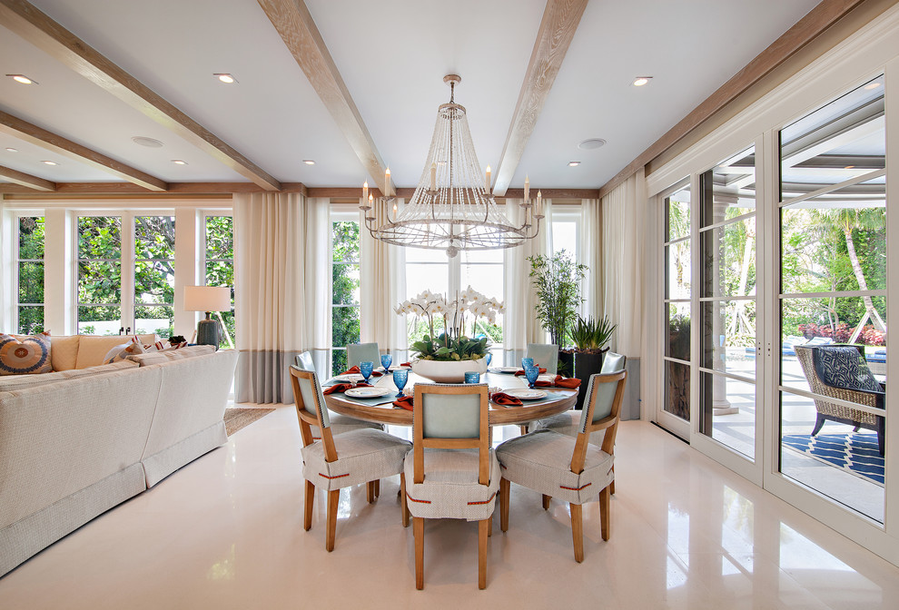 Photo of an expansive transitional kitchen/dining combo in Miami with white walls and porcelain floors.