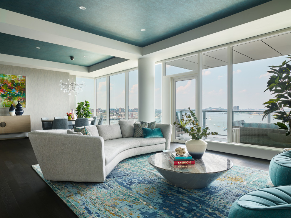 Contemporary open concept living room in Boston with dark hardwood floors, brown floor, recessed, wallpaper and grey walls.