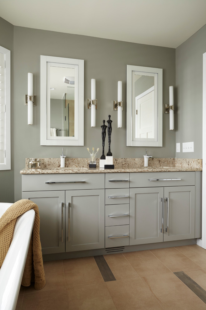 Small modern master bathroom in Minneapolis with an undermount sink, shaker cabinets, grey cabinets, solid surface benchtops, a freestanding tub, beige tile, ceramic tile, blue walls and ceramic floors.