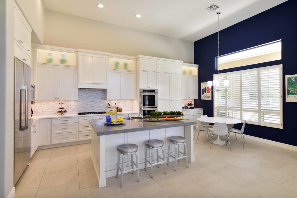 Design ideas for a large transitional u-shaped eat-in kitchen in Phoenix with an undermount sink, recessed-panel cabinets, white cabinets, quartz benchtops, white splashback, stone tile splashback, stainless steel appliances, porcelain floors, with island, beige floor and grey benchtop.