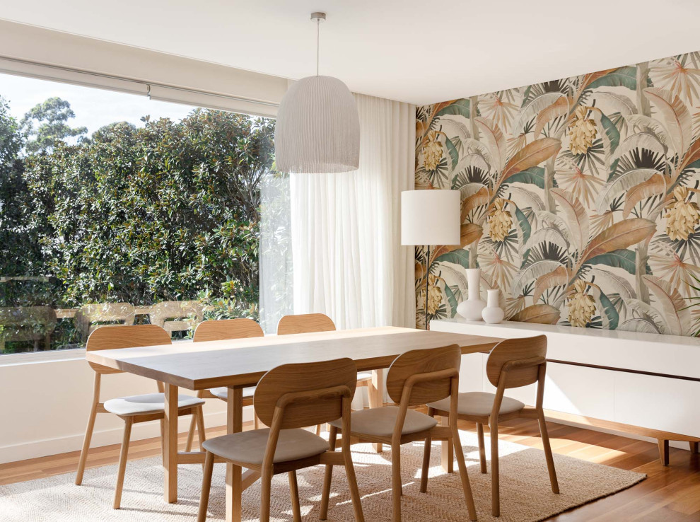 Inspiration for a modern dining room in Sydney with white walls, medium hardwood floors, brown floor and wallpaper.