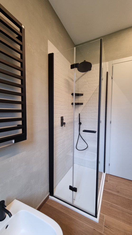 Design ideas for a small urban cloakroom in Milan with flat-panel cabinets, grey cabinets, a wall mounted toilet, beige tiles, beige walls, porcelain flooring, a vessel sink, wooden worktops, brown floors, beige worktops, a floating vanity unit, a drop ceiling and brick walls.