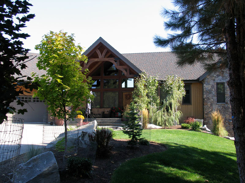 Mountain style brown one-story wood exterior home photo in Seattle