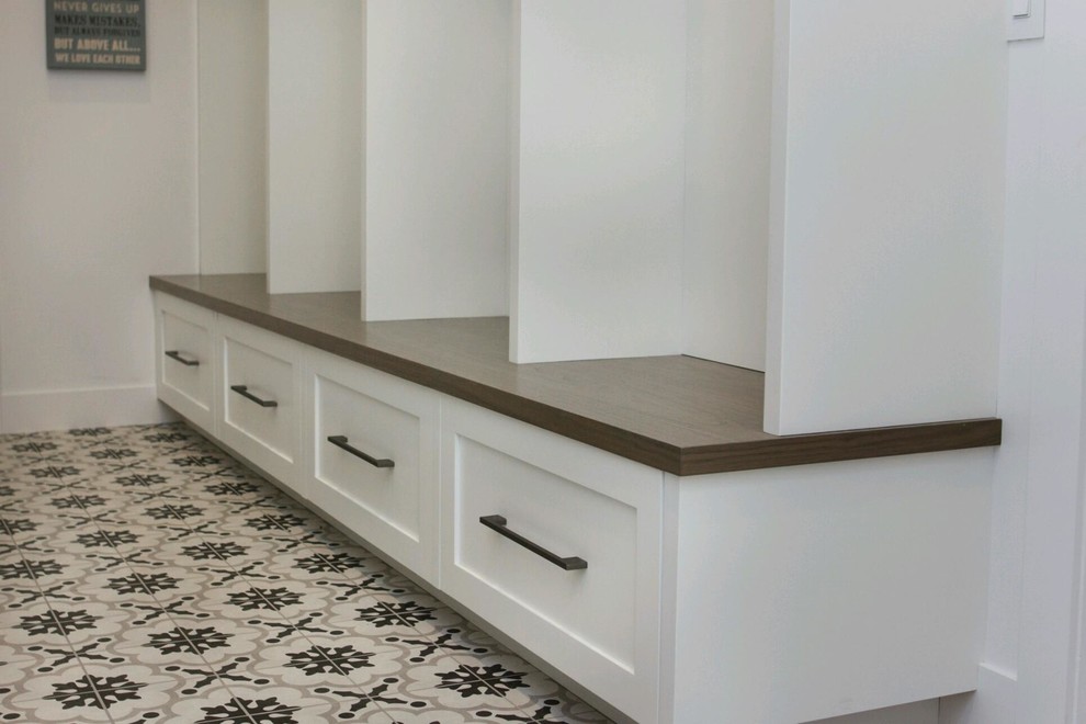 This is an example of a mid-sized modern mudroom in Phoenix with white walls, porcelain floors and grey floor.