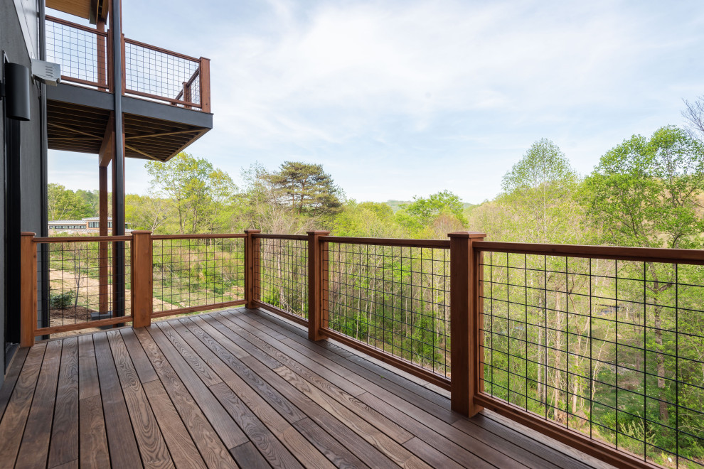 Deck - mid-sized transitional second story mixed material railing deck idea with a roof extension