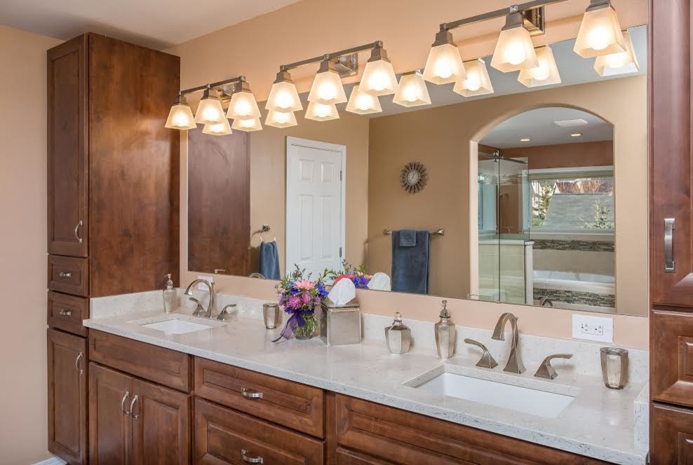 This is an example of a large traditional master bathroom in Other with raised-panel cabinets, dark wood cabinets, orange walls, an undermount sink and engineered quartz benchtops.